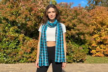 Load image into Gallery viewer, A mannequin torso dressed with a blue plaid cotton scarf in a checkered pattern.
